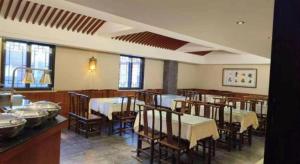 a dining room with tables and chairs in a restaurant at James Joyce Coffetel Xian Dayanta Metro Station Branch in Xi'an