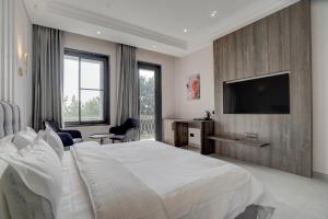 a bedroom with a large bed and a television at Nirvana Hotel & Banquet in Batāla +59 photos