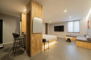 a bedroom with a bed and a table and a chair at Cheongju The City Hotel in Cheongju