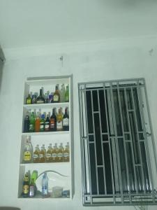 a refrigerator with its door open next to another refrigerator with drinks at Makucha Ya Simba Homestay and camping grounds in mwanza 