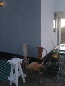 two chairs and a table in a room at Makucha Ya Simba Homestay and camping grounds in mwanza 