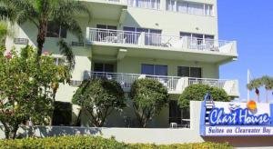 a large white building with a sign in front of it at Chart House Suites and Marina in Clearwater Beach