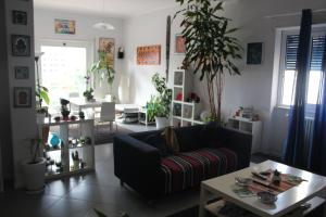 a living room with a couch and a table at Esedra B&B in Palermo
