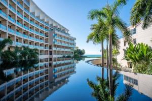 a view of a hotel with palm trees and a canal at Jinsha Seaview Hotel Sanya in Sanya