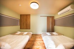 Postel nebo postele na pokoji v ubytování Private House KANADE