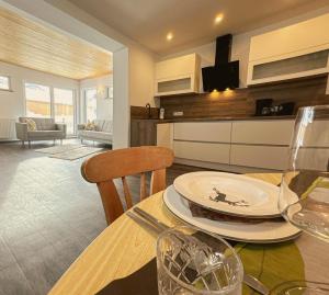 a dining room with a table and a living room at Goldberg-Aparts in Rauris