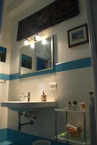 a bathroom with a sink and a mirror at Esedra B&B in Palermo +15 photos