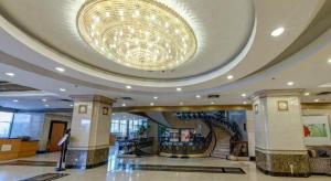 a large lobby with a large chandelier in a building at Fujian Hotel in Beijing
