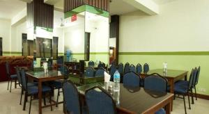 a dining room with tables and chairs in a room at OYO 381 Hotel Pashupati Plaza in Pashupatināth