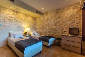 A bed or beds in a room at Exensian Villas & Suites