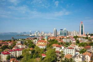 a view of a city with skyscrapers at Sky World Hotel Qingdao in Qingdao