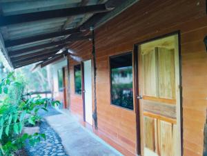 a wooden house with a door and a porch at Koh jum Mutu Home Stay in Ban Ko Phrao +53 photos