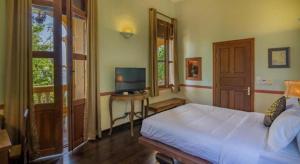 TV a/nebo společenská místnost v ubytování Le Relais de Chhlong