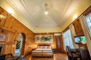 a living room with wooden walls and a ceiling at Grand Norling Hotel's Resort in Baudhatinchule