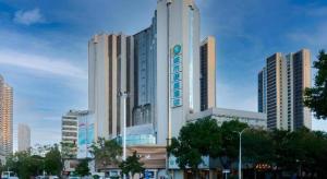 a large building in a city with buildings at City Comfort Inn Wuhan Badajia Heping Park Metro Station in Wuhan