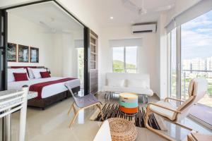 a bedroom with a king sized bed and a balcony at Terrazas Tayrona Travelers Apartamentos y Suites in Santa Marta