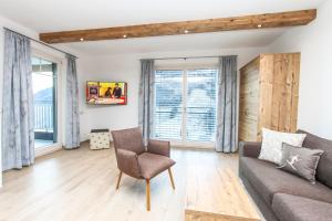 a living room with a couch and a chair at Eberharthof in Saalbach-Hinterglemm