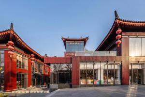 an exterior view of a building with a tower at Xana Hotelle XiAn Gig Wild Goose Pagoda Branch in Xi'an