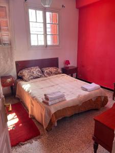 En eller flere senge i et værelse på Maison Agama