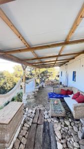 a patio with couches and a bed on a stone floor at GP Cortijo Palmera  +14 photos