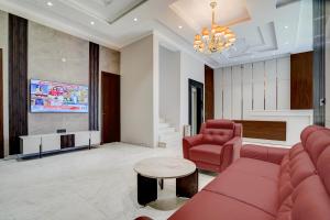 a living room with a couch and a table at Nirvana Hotel & Banquet in Batāla
