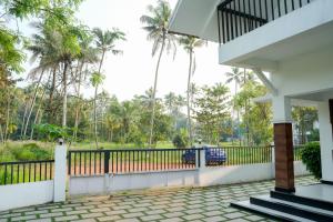 a view from the outside of a house with palm trees at Paradise Riviera in Ernakulam +23 photos