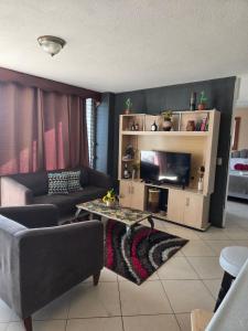 a living room with a couch and a table at Apartamento 1005 Cortijo in Guatemala