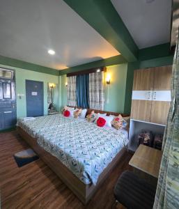a large bed in a room with green walls at Sonali Megh in Darjeeling +40 photos