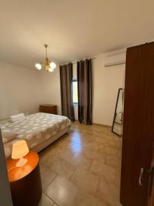 a bedroom with a bed and a table in it at Masseria Marotta Appartamento in Santa Paolina