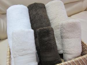 a basket filled with different types of towels at Okinawa Pension Minami in Nanjo