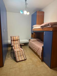 a small room with a bed and a chair at Masseria Marotta Appartamento in Santa Paolina +8 photos