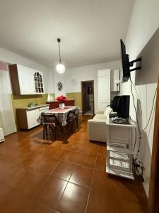 a living room with a couch and a table with a tv at Masseria Marotta Appartamento in Santa Paolina
