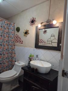 a bathroom with a toilet and a sink at Apartamento 1005 Cortijo in Guatemala +9 photos