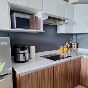 a kitchen with white cabinets and a counter top at Apartamento 1005 Cortijo in Guatemala