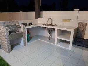 a kitchen with a sink and a sink at Homestay AGM in Mersing
