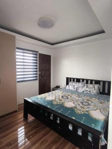 a bedroom with a large bed in a room at Villa Maria 1 in Bacolod