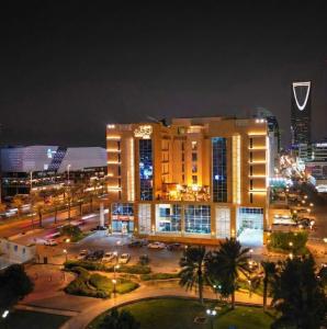 a large building in a city at night at Awfad Hotel in Riyadh