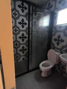 a bathroom with a toilet and a sink at Villa Maria 1 in Bacolod