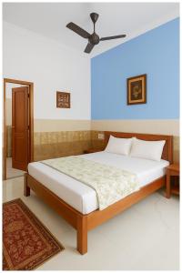 um quarto com uma cama e um ventilador de teto em Ayodhya The Kanha- Shiva Homestay Near Parking and Free Wifi Facility - Fully Air conditioning Comfortable Room - Best Budget Homestay IN Ayodhya em Ayodhya mais 13 fotografias