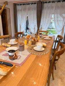 a long wooden table with food on top of it at Chez Eric et Nath in Bois-Herpin