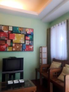 TV a/nebo společenská místnost v ubytování Gomez Guest House