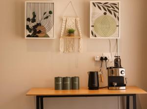 a table with a coffee maker on top of it at Rissie's Villa in Gordonʼs Bay