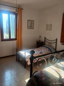 a bedroom with two beds and a window at Casa Branchetti in Quarrata +14 photos