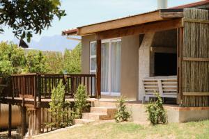 a porch of a house with a deck at Rissie's Villa in Gordonʼs Bay