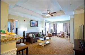 a living room with a couch and a table at Calypso Cay Vacation Villas in Kissimmee
