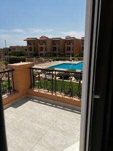 a balcony with a view of a swimming pool at Private Villa Sea View 5BR in Ain Sokhna
