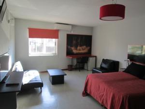 Ένα ή περισσότερα κρεβάτια σε δωμάτιο στο Cañas Suites Urbanas