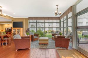 an open living room with furniture and windows at The Inn at Apple Valley, an Ascend Collection Hotel in Pigeon Forge +135 photos