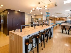 a bar in a restaurant with bar stools at Comfort Hotel Kokura in Kitakyushu
