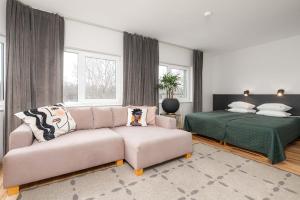 a living room with a couch and a bed at Hotel Emmi in Pärnu
